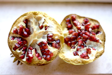 Ripe organic pomegranate, cut in half. Selective focus.