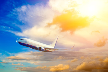Airplane take off on the blue sky, big jet plane flying on blue cloudy sky background,idyllic sunlight on cloud fluffy