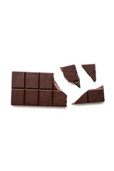 Broken dark chocolate bar isolated on white table. Vertical composition. Top view