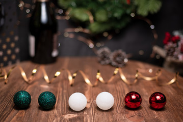 Smooth shady christmas and new year decoration background with round bokeh, golden ribbon and bottle of champagne and New Year's spheres
