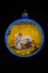 Obraz na płótnie Canvas Ornament for the Christmas tree, on a black background. Angels in a yellow circle, with a blue border.