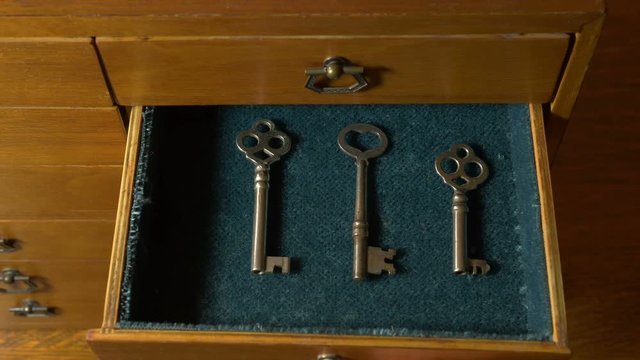 Taking an old skeleton key out of a mysterious chest of drawers