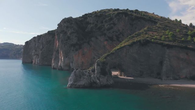 Beach behind the natural arch in rock at a sea shore. Palinuro, Italy. Aerial shot
