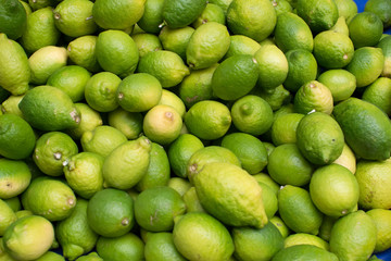 green lemons are on the market stall, selling citrus fruits, harvesting, .backgrounds