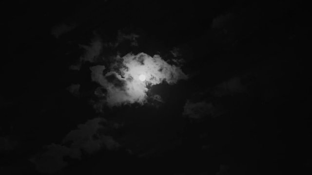Moon with time lapse clouds. Black and white.
