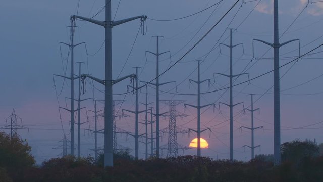 Hydro electric towers with sun going down in Toronto, Ontario, Canada. 