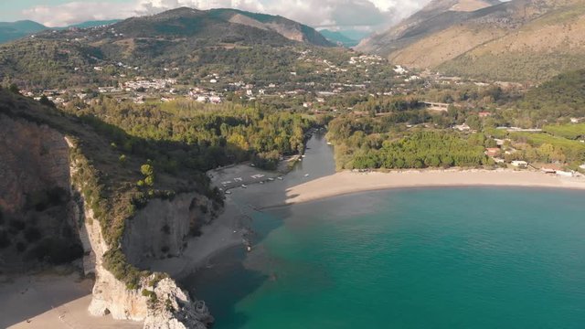 Approaching sea shore. Rock, beach and river mouth. Aerial shot of Palinuro, Italy
