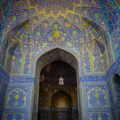 Fototapeta na wymiar A tall arch decorated with intricate blue mosaic artwork, at the UNESCO listed Imam Mosque, in Esfahan, Iran