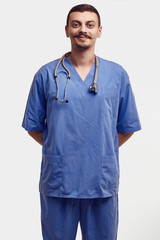 Handsome young arabic doctor with fancy mustache in blue