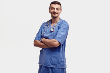 Handsome young arabic doctor with fancy mustache in blue