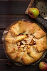 Homemade Apple Galette on rustic wooden background, overhead view