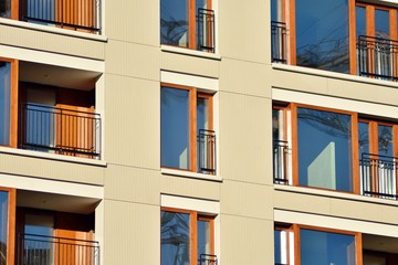 Fototapeta premium Modern apartment buildings on a sunny day with a blue sky. Facade of a modern apartment building