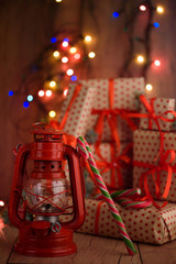 New Year's gifts with red ribbon. Packing Christmas gifts. Garland with lights. New Year.