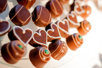 bonbons in rounded and heart-shaped shapes on glass tray