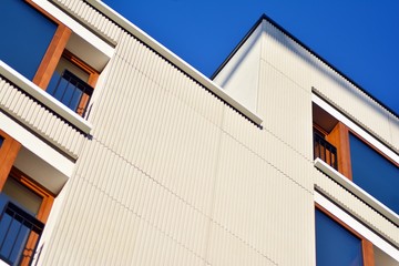 Modern apartment buildings on a sunny day with a blue sky. Facade of a modern apartment building