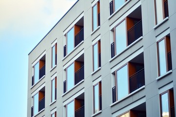 Modern apartment buildings on a sunny day with a blue sky. Facade of a modern apartment building