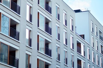 Modern apartment buildings on a sunny day with a blue sky. Facade of a modern apartment building