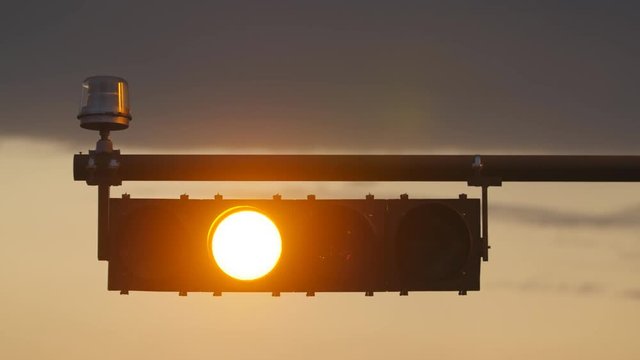 Horizontal stoplight changing from green to amber to red. Quebec, Canada.