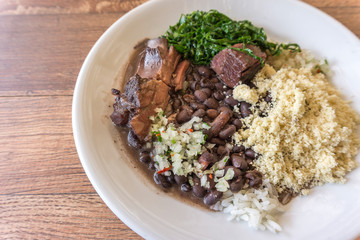 White dish with ingredients of feijoada, typical food of Brazil