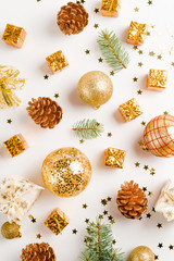 christmas or new year composition. christmas decorations in gold colors on white background, holiday and celebration concept for postcard or invitation. top view, flat lay