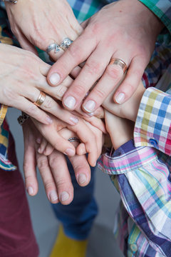 Closeup View of Young Caucasian People Connecting Their Hands Together. Stack of Five Pairs of Hands Demonstrating Unity, Teamwork and Friendship