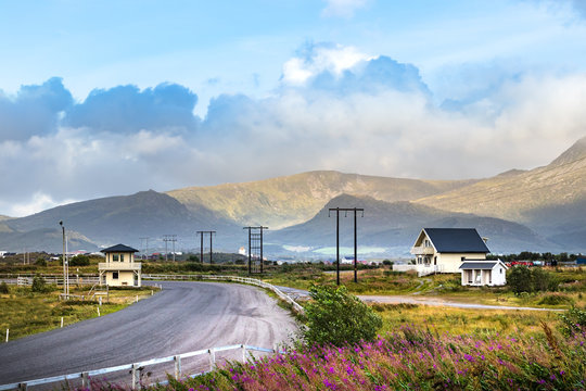View from a road with mountains and wooden houses, Leknes, Norway.
