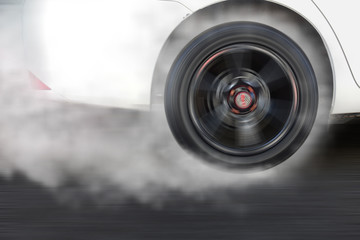 White car wheel drifting and smoking on track