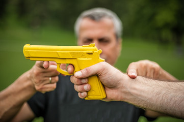 Gun point. Kapap instructor demonstrates self defense techniques against threat