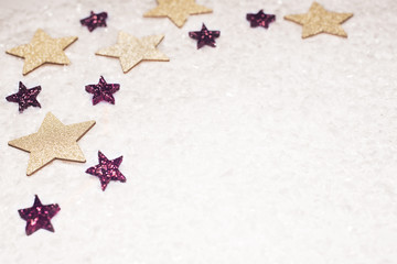 Fototapeta na wymiar Christmas background, with golds and purple glitter stars and snow - sophisticated, luxury - copyspace