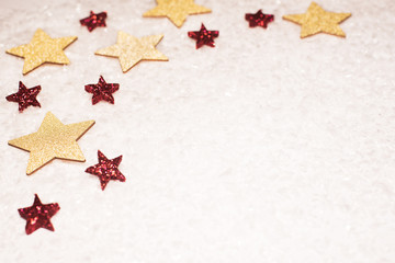 Christmas background, with gold and red glitter stars and snow - sophisticated, luxury - copyspace