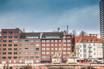 Buildings on the banks of the Elbe River on a cloudy end of winter day