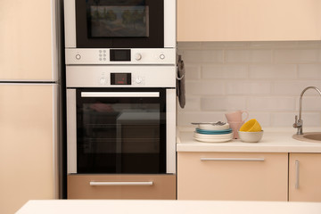 Fototapeta premium Clean dishware and cutlery on counter in kitchen