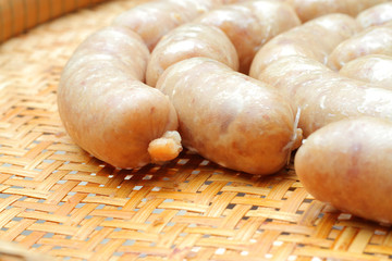 raw homemade sausage on a wooden board