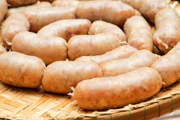 raw homemade sausage on a wooden board
