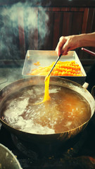 Hand are making of traditional Thai dessert, Foi Thong or Golden Egg strips