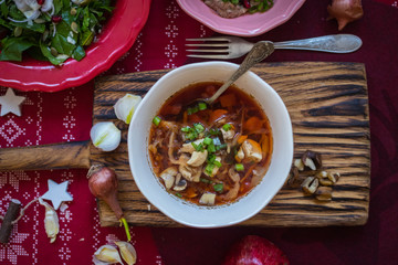 Happy Christmas food. Hot traditional beetroot, cabbage red soup - borsch for lunch or dinner. Red New Year background. Vegan and vegetarian