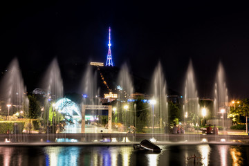 Fototapeta premium Georgia, Tbilisi - July, 3, 2018. Fountain at Rike square Tbilisi at night