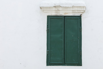 Obraz na płótnie Canvas Old green wood window on a white wall