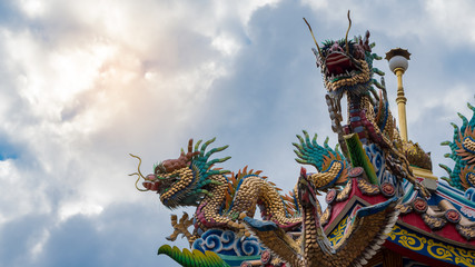 Chinese court with dragon statue on and sky