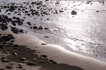  Big smooth black beach stones in the water