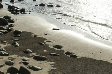  Big smooth black beach stones in the water