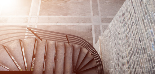 A rotating staircase and a brick wall