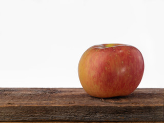 Red fresh apple on a wood shelf with copy space.