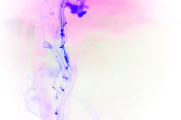 a drop of paint pouring in water