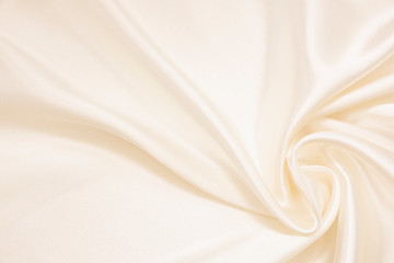 Obraz premium The texture of the satin fabric of beige color for the background