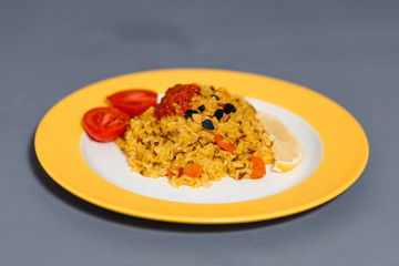 appetizing pilaf with turmeric and barberry, raw rice and black rice. Yellow pilaf