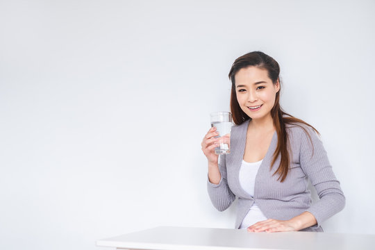 Young Asian Woman Drinking Fresh Water For Healthy Over White Background