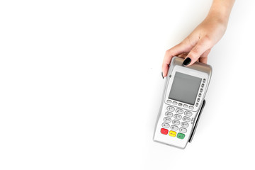 Offer a payment terminal. Woman's hand hold POS terminal on white background top view copy space