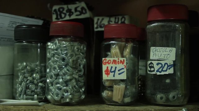 Shelf With Screw Jars And Nails In The Hardware Store.