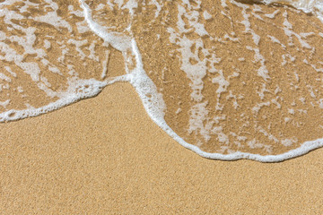 waves brush sands at beach